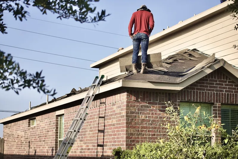 Professional roofer working on a residential roof in Crown Heights